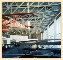 Vintage aircraft hanging inside an aviation museum