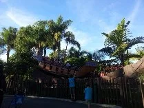 Palm trees and a pirate-ship play area at a theme park