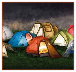 Colourful tents lit up at a campground at dusk