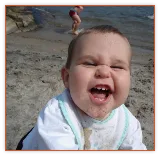 Laughing baby at the beach