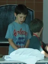 Two boys working on a project at a museum table