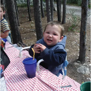 Toddler at a picnic table in the forest